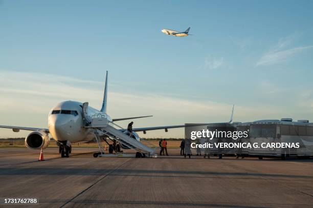 Buses transporting migrants to board the the first deportation flight of undocumented Venezuelans after a US-Venezuelan agreement are seen as another...