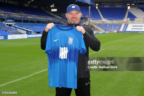 Wayne Rooney, Manager of Birmingham City holds up a Birmingham City home shirt as he is presented as new Birmingham City manager at St Andrew's...