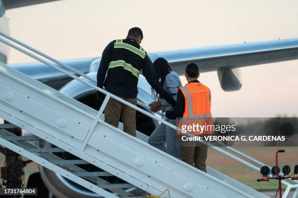 Woman in shackles boards the first deportation flight of undocumented Venezuelans after a US-Venezuelan agreement in Harlingen, Texas, on October 18,...