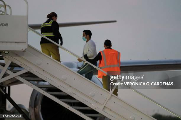 Man in shackles boards the first deportation flight of undocumented Venezuelans after a US-Venezuelan agreement in Harlingen, Texas, on October 18,...