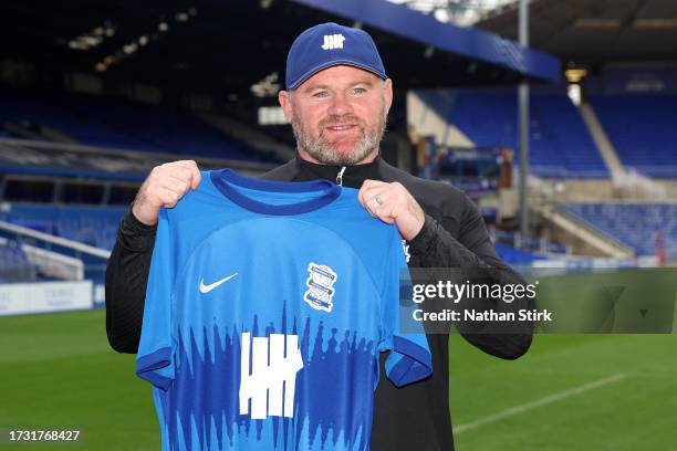 Wayne Rooney, Manager of Birmingham City holds up a Birmingham City home shirt as he is presented as new Birmingham City manager at St Andrew's...