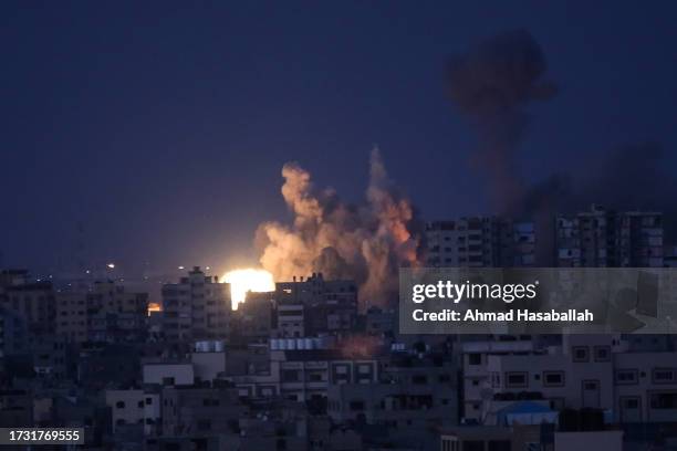 An explosion at a residential tower caused by Israeli bombing raids in the northern Gaza Strip on October 12, 2023 in Gaza City, Gaza. At least 1,200...