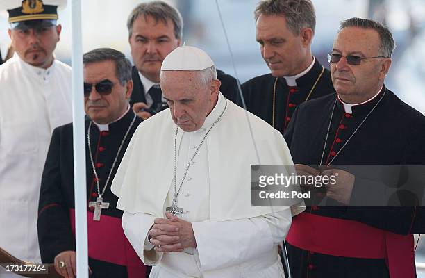 Pope Francis looks on moments before laying a wreath on July 8, 2013 in Lampedusa, Italy. On his first official trip outside Rome, Pope Francis...