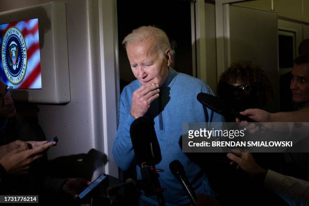 President Joe Biden speaks to the press aboard Air Force One during a refueling stop at Ramstein Air Base on October 18, 2023 as he returns from a...