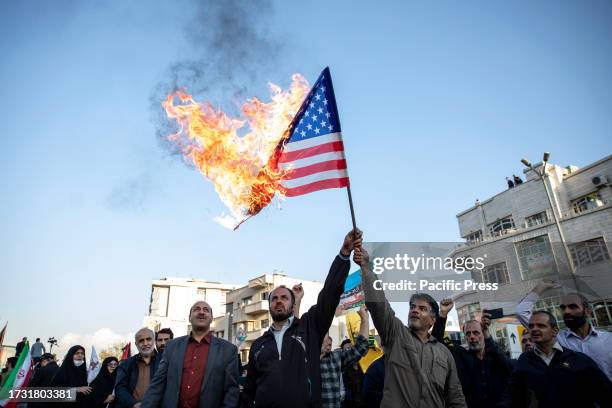 Iranian protestors burn a U.S. Flag during an anti-Israel rally at Enqelab-e-Eslami Square.