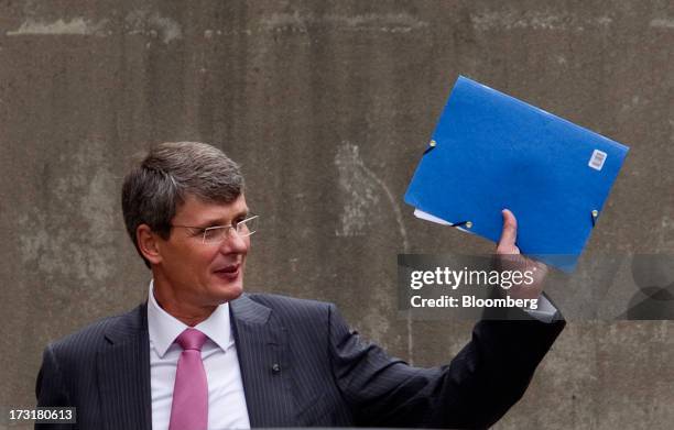 Thorsten Heins, chief executive officer of BlackBerry, waves while leaving the company's annual general meeting in Waterloo, Ontario, Canada, on...