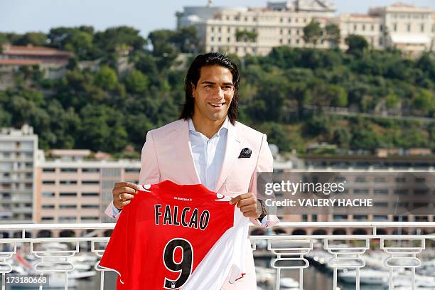 Colombian forward Radamel Falcao poses while holding his new jersey from French L1 Monaco football club after a press conference on July 9, 2013 in...