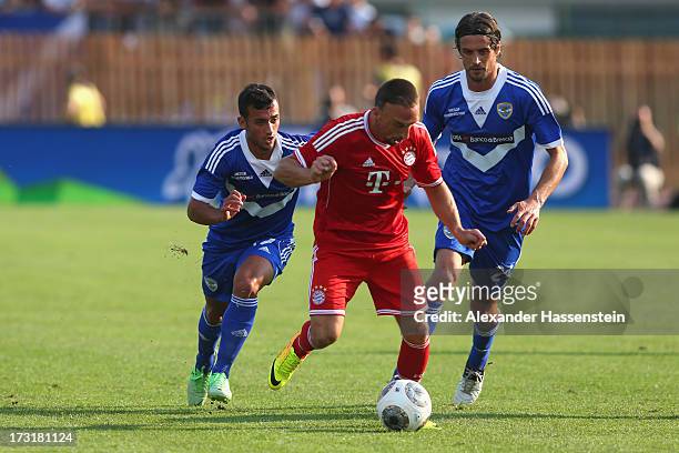 Franck Ribery of Bayern Muenchen battles for the ball with Ahmad Benali of Brescia and his team mate Massimo Paci during the friendly match between...