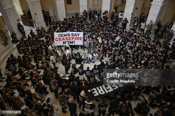Police officers take a protester into custody as Jewish activists stage pro-Palestinian demonstration at United States Capitol building in Washington...