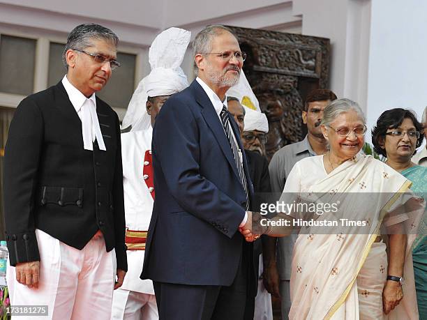 Newly appointed Lieutenant Governor of Delhi, Najeeb Jung, shake hand with Delhi Chief Minister Sheila Dikshit with Chief Justice of the Delhi High...