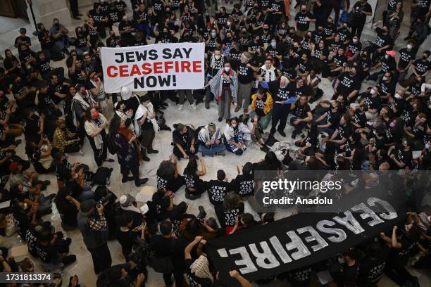 Police officers take a protester into custody as Jewish activists stage pro-Palestinian demonstration at United States Capitol building in Washington...