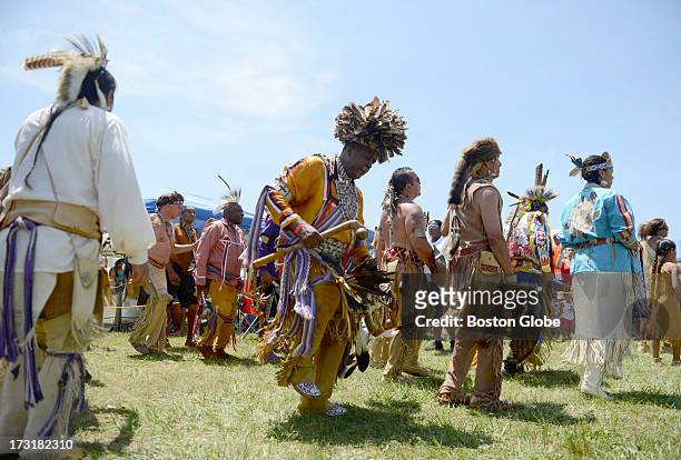 Native Americans take part in intertribal dancing during the 92nd Mashpee Wampanoag Powwow at the Barnstable County Fairgrounds in East Falmouth,...