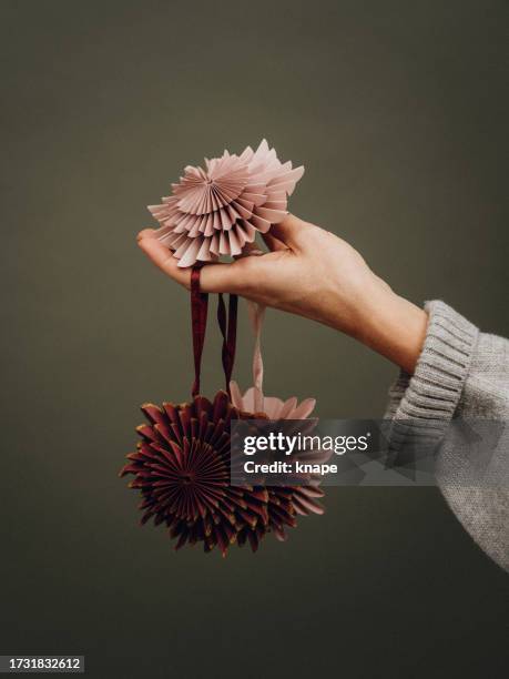 woman holding christmas decoration ornaments in pastel paper natural color scheme - pink colour scheme stock pictures, royalty-free photos & images