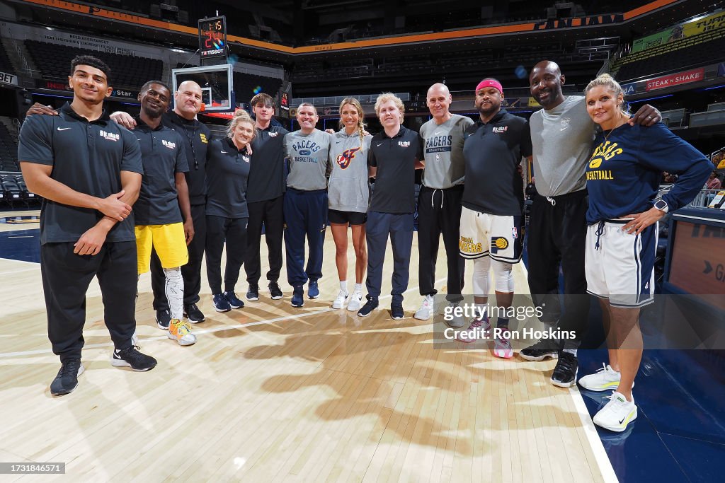 Indiana Pacers coaching staff and Lexi Hull of the Indiana Fever pose