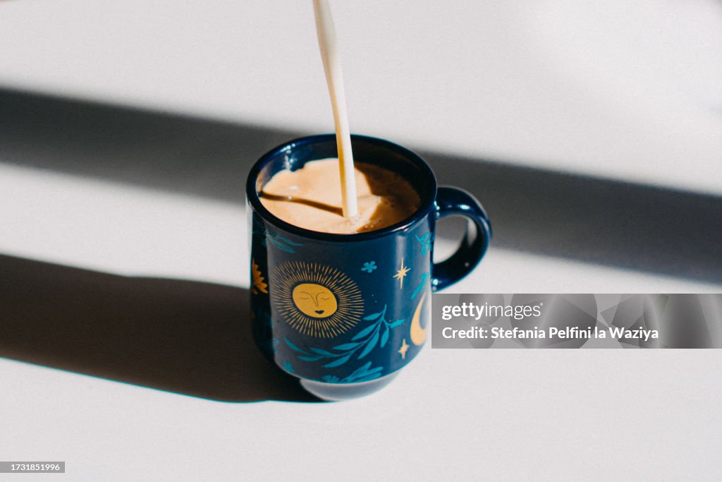 Creamer Pouring in Espresso Cup