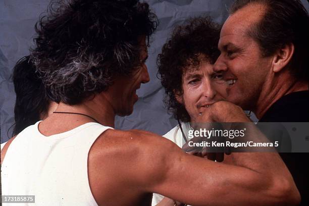 Performers Keith Richards and Bob Dylan are photographed with Jack Nicholson backstage at Live Aid on July 13, 1985 at JFK Stadium in Philadelphia,...