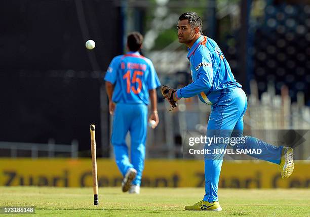 Indian cricket team regular captain Mahendra Sing Dhoni warms up before the start of the second innings during the sixth match of the Tri-Nation...