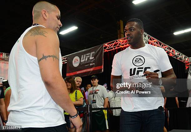 Light heavyweight champion Jon Jones signs autographs for fans during day one of the UFC Fan Expo Las Vegas 2013 at the Mandalay Bay Convention...