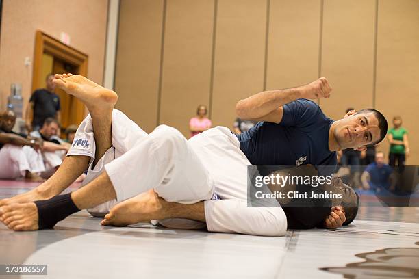 Fans look on during a jiu-jitsu seminar during day one of the UFC Fan Expo Las Vegas 2013 at the Mandalay Bay Convention Center on July 5, 2013 in...