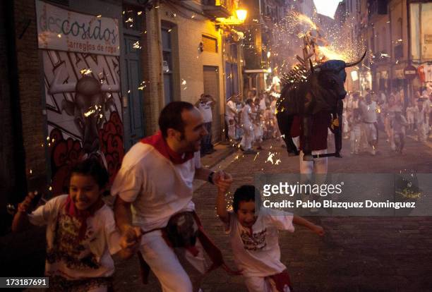 Toro del Fuego is run through the streets of Pamplona on the fourth day of the San Fermin Running Of The Bulls festival, on July 9, 2013 in Pamplona,...