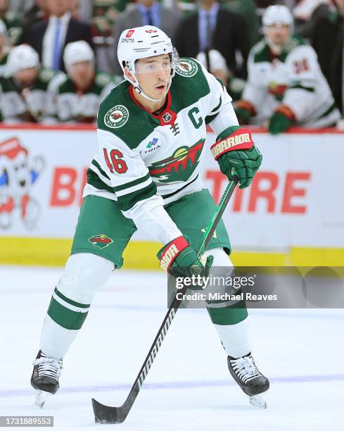 Jared Spurgeon of the Minnesota Wild skates with the puck against the Chicago Blackhawks during the first period of a preseason game at the United...