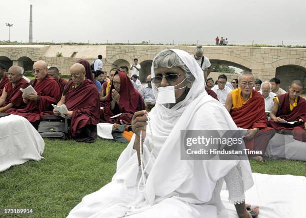 Jain monk and others offer prayers for peace during an inter-faith prayer meeting at Raj Ghat, the memorial of the Mahatma Gandhi on July 9, 2013 in...