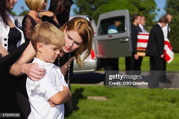 mother and son at a funeral - military widow stock pictures, royalty-free photos & images