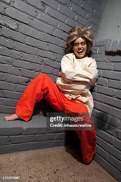 crazy woman wearing a straight jacket in an asylum - dwangbuis stockfoto's en -beelden