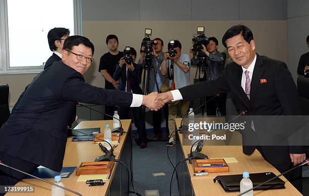 Suh Ho, the head of South Korea's working-level delegation shakes hands with his North Korean counterpart Park Chol-Su during their meeting at...
