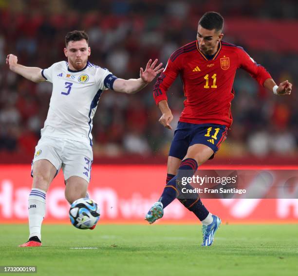 Ferran Torres of Spain shoots whilst under pressure from Andrew Robertson of Scotland during the UEFA EURO 2024 European qualifier match between...