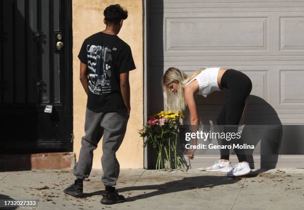 Youth leave flowers at the scene where four women were killed in a multi-vehicle crash along the Pacific Coast Highway in Malibu on October 18, 2023....