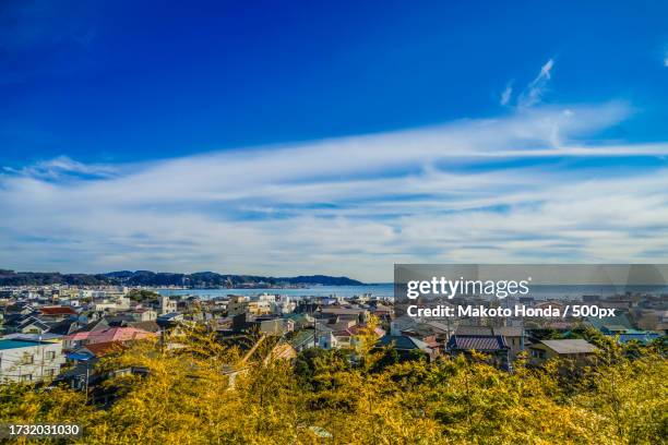 high angle view of townscape against blue sky - zushi kanagawa stockfoto's en -beelden