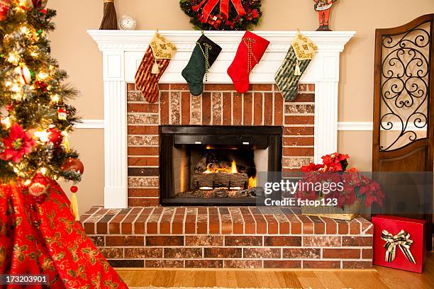 traditional fireplace with stocking, wreath and christmas tree - fireplace stock pictures, royalty-free photos & images