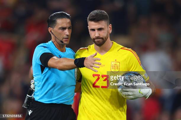 Referee, Serdar Gozubuyuk reacts with Unai Simon of Spain after a VAR check to disallow the goal scored by Scott McTominay of Scotland the UEFA EURO...