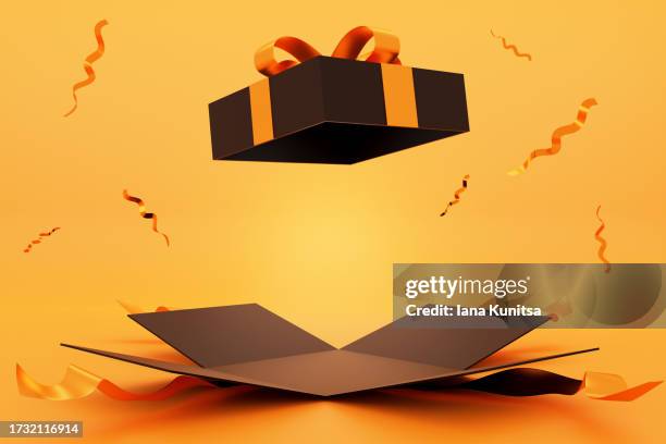 black gift box with yellow bow on bright orange background. beautiful festive 3d banner. place for your product, copy space. concept halloween and black friday, sale. design element. - caja de regalo fotografías e imágenes de stock