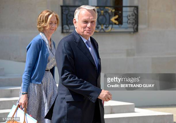 French Prime Minister Jean-Marc Ayrault and French Minister for External Trade Nicole Bricq leave at the end of the weekly cabinet meeting at the...