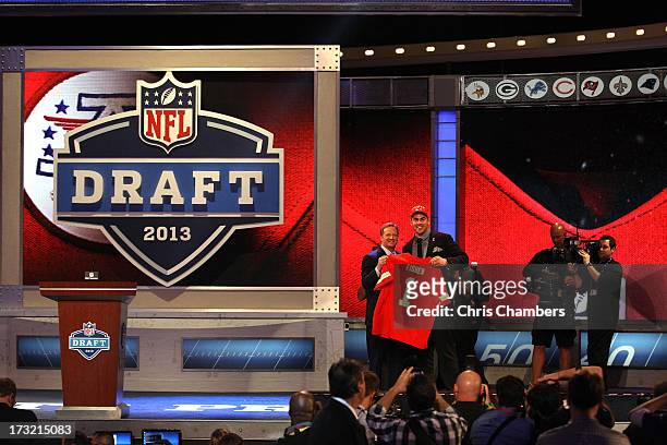Eric Fisher of Central Michigan Chippewas stands on stage with NFL Commissioner Roger Goodell after Fisher was picked overall by the Kansas City...