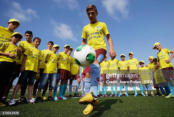 Kids play football during a Fifa 'fair play' event on July 10, 2013 in Trabzon, Turkey.