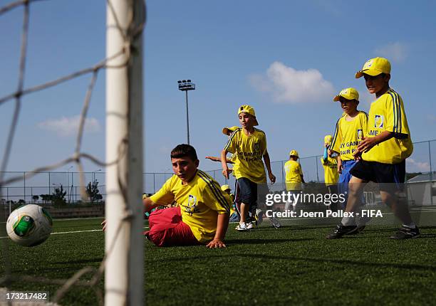 Kids play football during a Fifa 'fair play' event on July 10, 2013 in Trabzon, Turkey.
