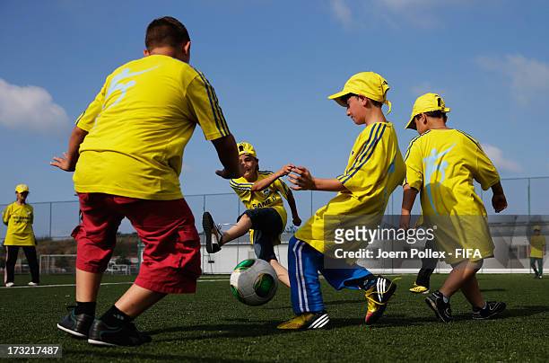 Kids play football during a Fifa 'fair play' event on July 10, 2013 in Trabzon, Turkey.