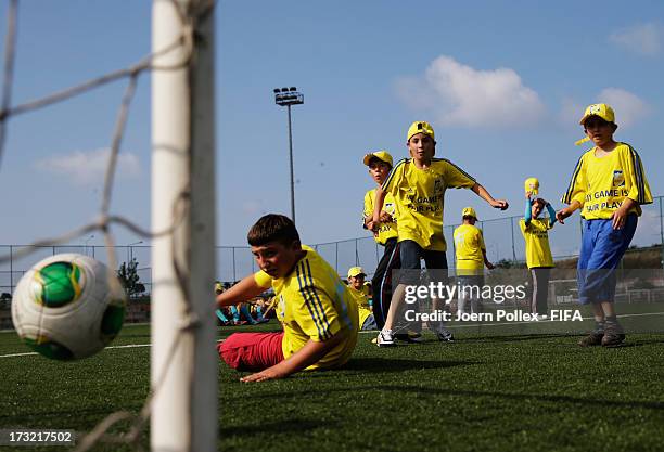 Kids play football during a Fifa 'fair play' event on July 10, 2013 in Trabzon, Turkey.