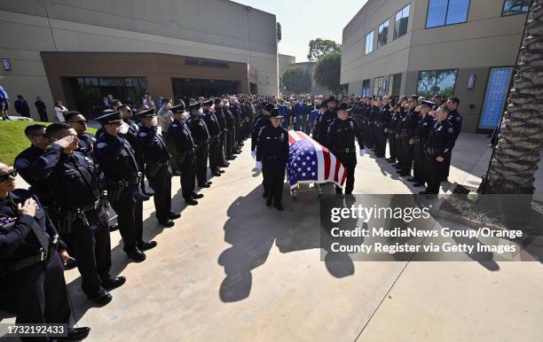 Cypress, CA The body of Manhattan Beach Police Department motorcycle officer Chad Swanson enters SeaCoast Grace Church in Cypress, CA, on Wednesday,...