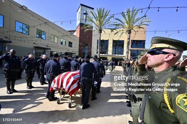 Cypress, CA The body of Manhattan Beach Police Department motorcycle officer Chad Swanson enters SeaCoast Grace Church in Cypress, CA, on Wednesday,...