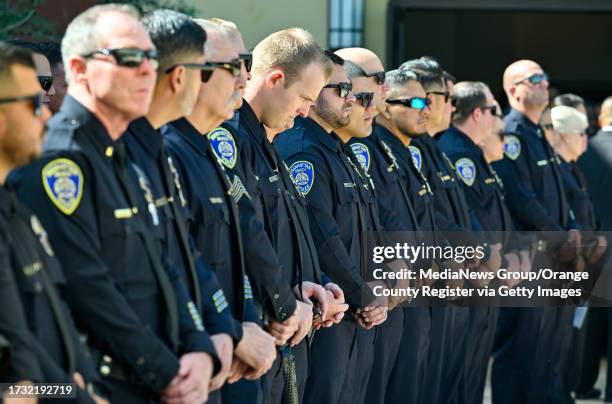 Cypress, CA Manhattan Beach police officers stand outside SeaCoast Grace Church at the end of motorcycle officer Chad Swanson's funeral in Cypress,...