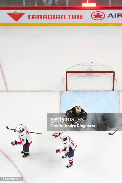 Alex Ovechkin the Washington Capitals celebrates a goal scored by teammate Matthew Phillips with teammate Dylan Strome against Anton Forsberg of the...