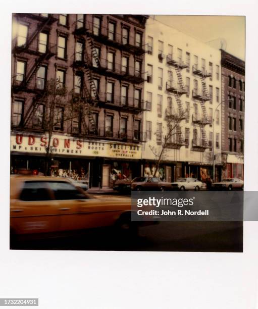 Polaroid photo of a taxi driving past the Hudson's boots and shoe store in New York, New York, circa 1978.