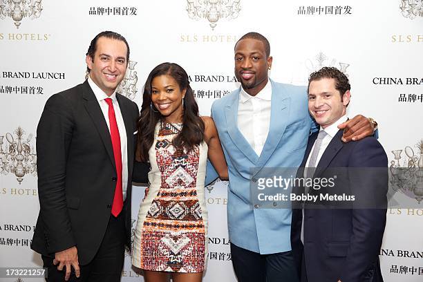 Group president Sam Bakhshandehpour, Gabrielle Union, Dwyane Wade and Director of Hotel Operations Michael Talansky pose for a photograph at the SLS...