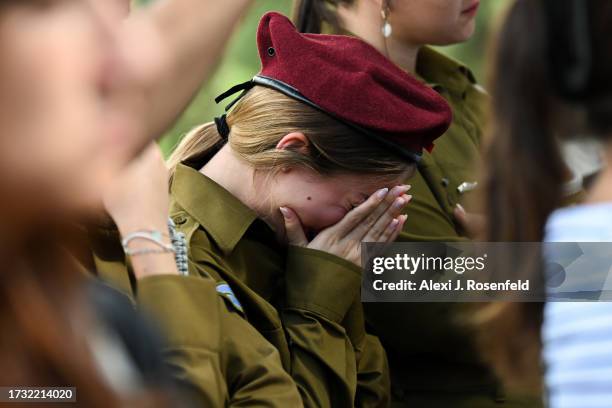 Soldier cries during the funeral of Valentin Ghnassia who was killed in a battle with Palestinian militants at Kibbutz Be’eeri near the Israeli...