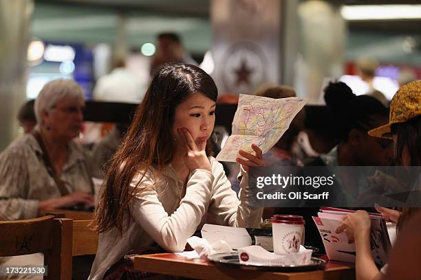 Woman studies a map of the London Underground network in a cafe on July 10, 2013 in London, England.