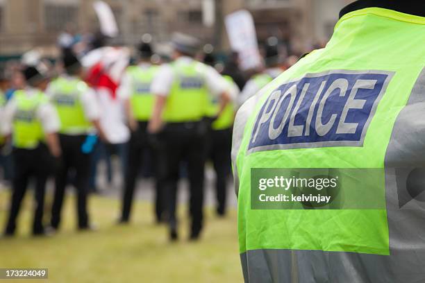 police at a protest rally - police force uk stock pictures, royalty-free photos & images